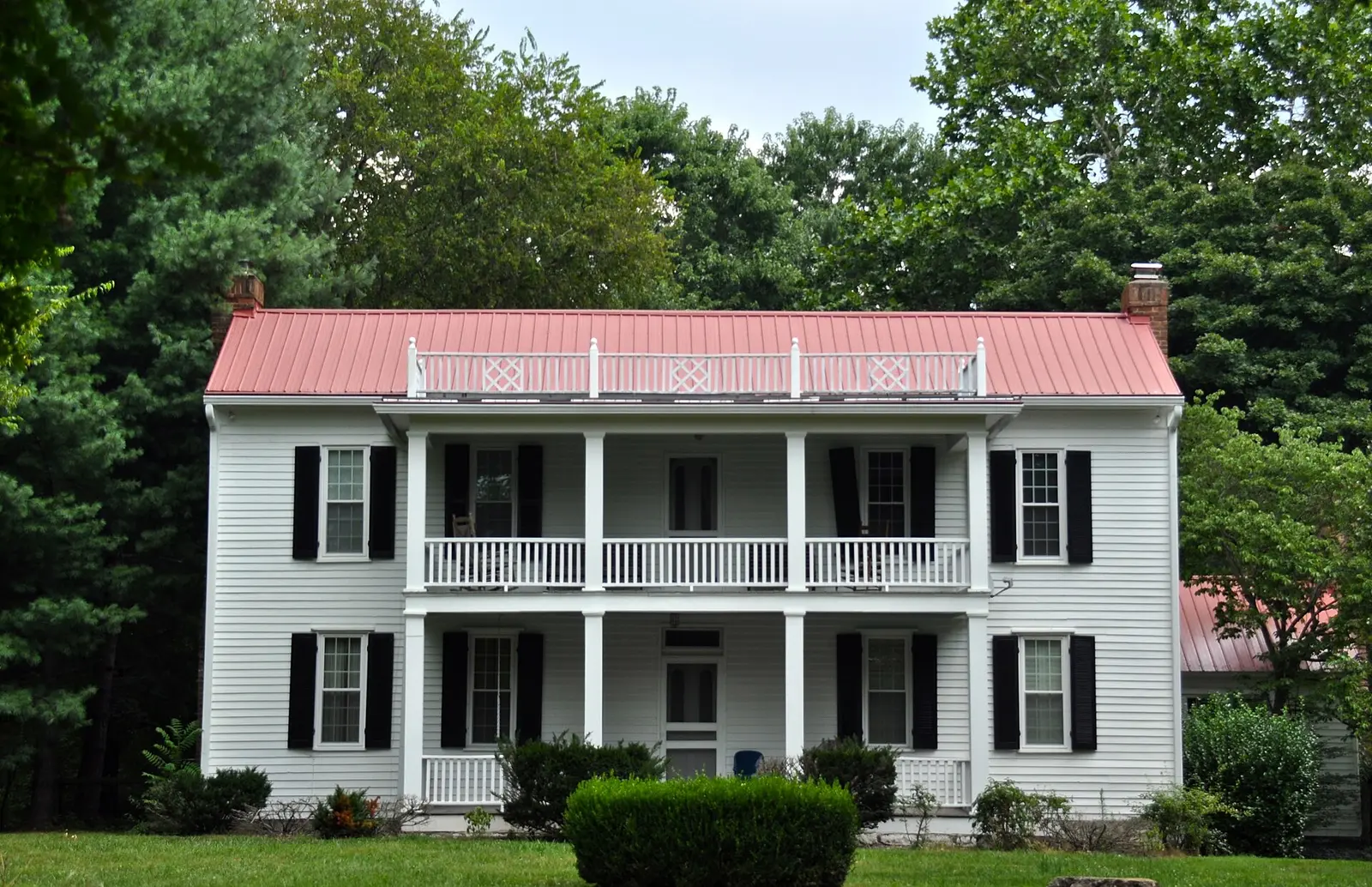 The Alexander Smith House, a two-story white frame house with a double porch, on Wilson Pike in Brentwood