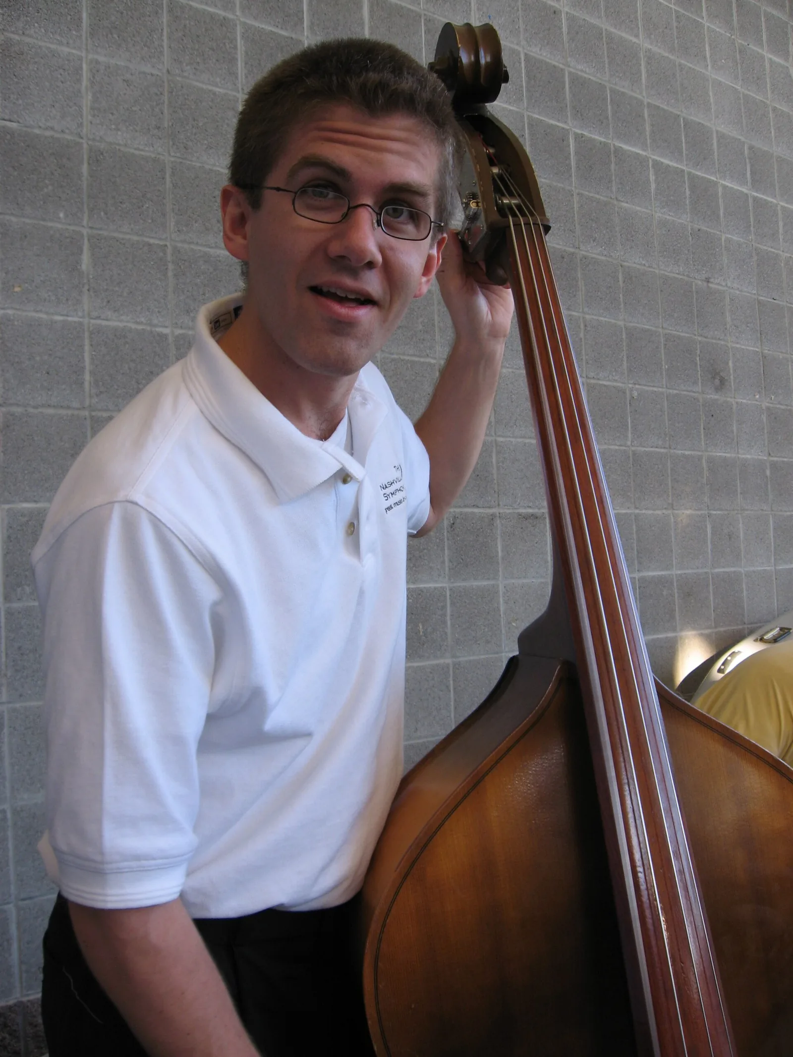A Nashville Symphony bassist tunes up before the orchestra's outdoor concert at Crockett Park in Brentwood
