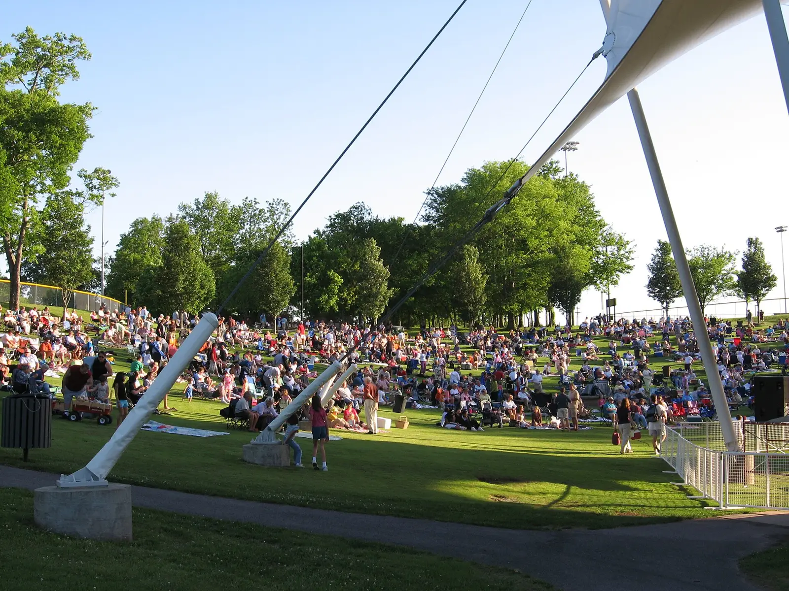 A crowd on blankets and lawn chairs on the hill at the Eddy Arnold Amphitheater in Crockett Park, Brentwood, during a summer concert